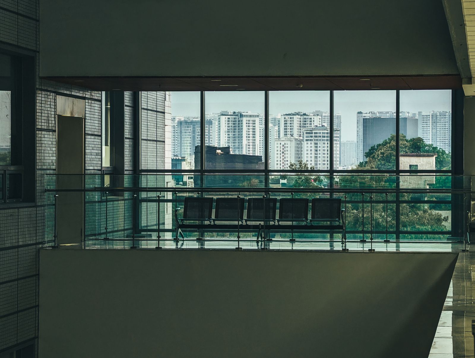 Institutional building interior overlooking a city skyline